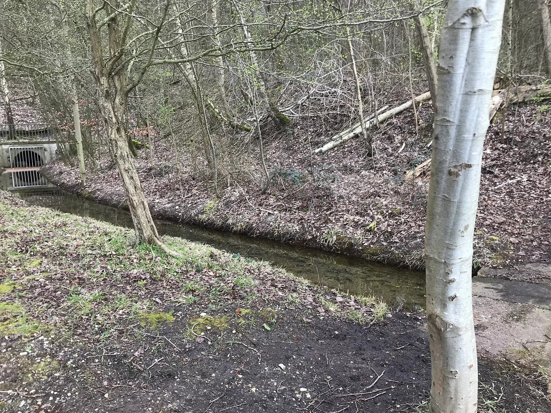 Canal feeding the Heider Bergsee, culverted underneath a railroad track and a Bundesstraße