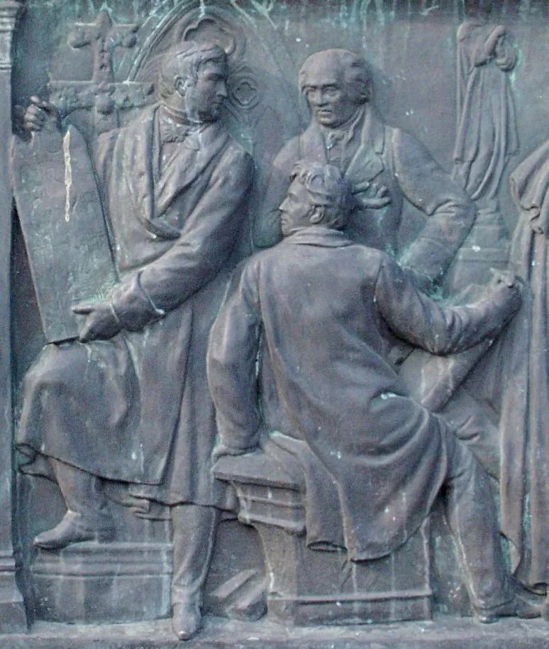 Friedrich Wilhelm III .-Reiterstandbild auf dem Kölner Heumarkt. Detail des Relief an der Südseite mit Melchior und Sulpiz Boisserée und Ferdinand Franz Wallraf