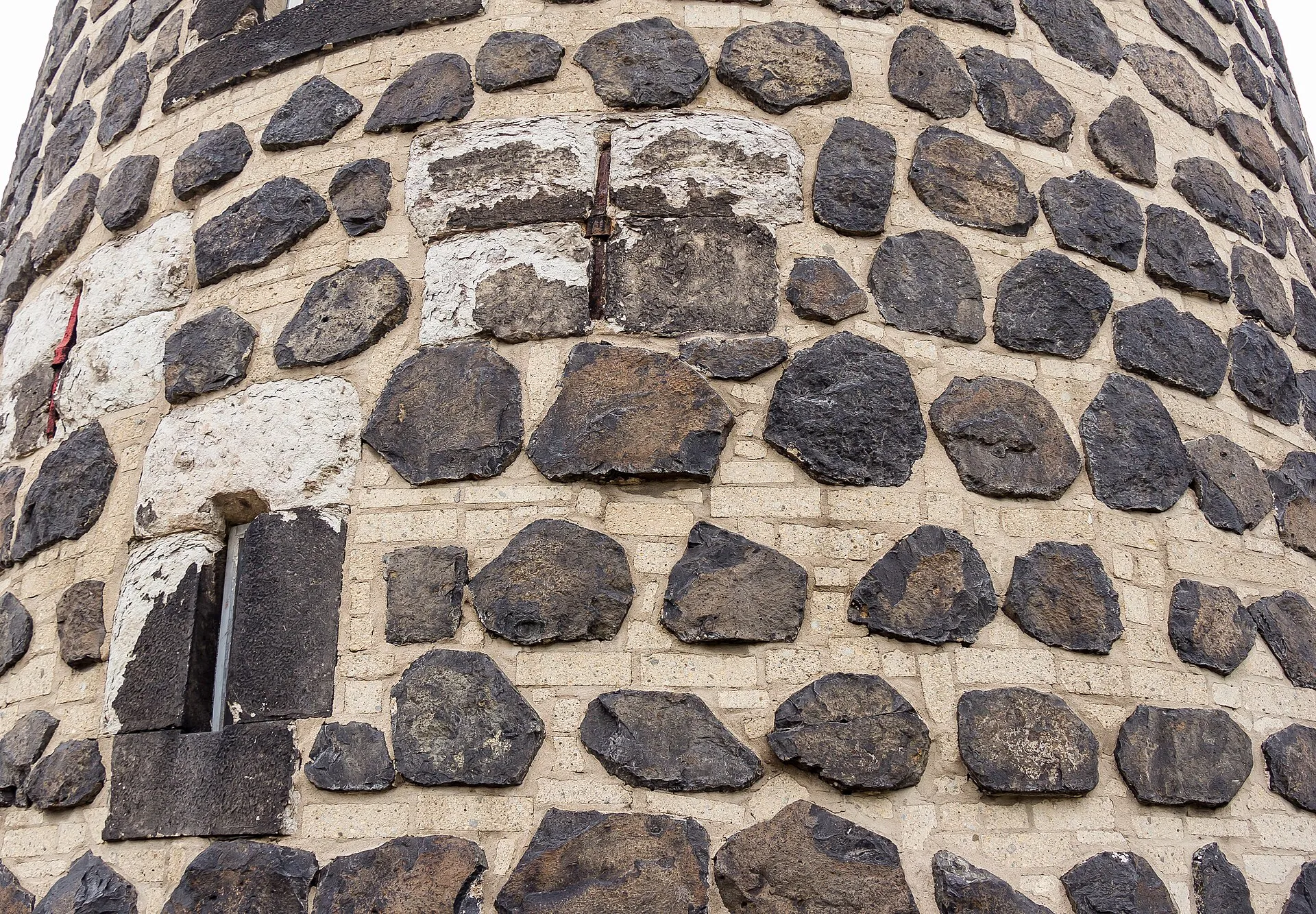 Gereonsmühle Köln mit Stadtmauer. Die Mühle ist aus Säulenbasalt und Tuffsteinschichten im Wechsel errichtet.