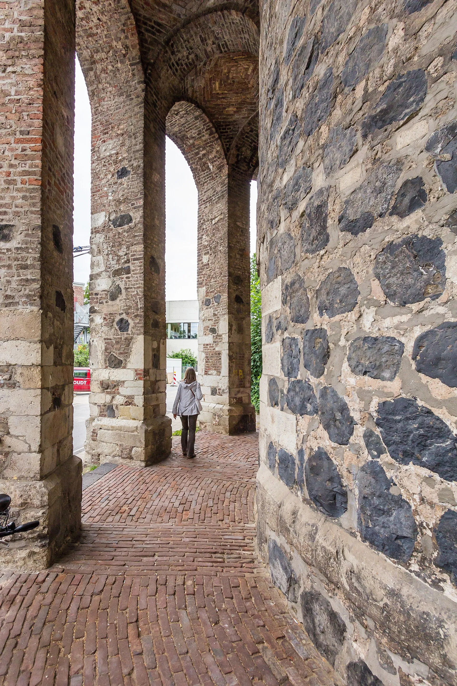 Gereonsmühle Köln mit Stadtmauer. Rundbogig miteinander verbundene Pfeiler stützen den Mühlengang. Rechts der untere Teil der Mühle, bestehend aus Säulenbasalt