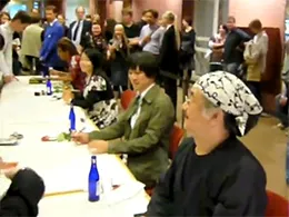 One cropped frame of a video taken during the autograph session in the Kölner Philharmonie before the Symphonic Fantasies concert, depicting (from left to right