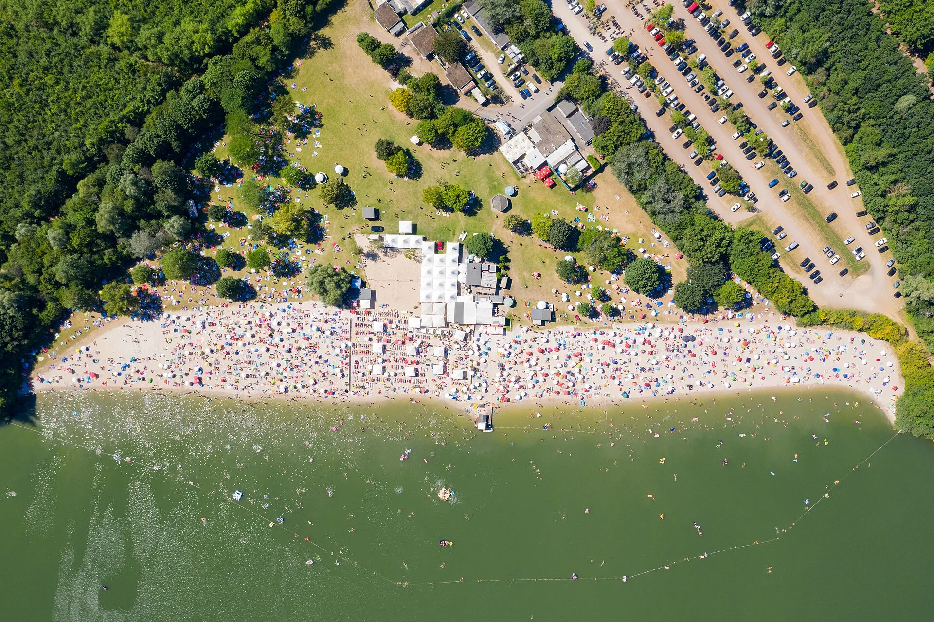 Aerial view of the sandy beach and of the swimming area of Otto-Maigler-See in Hürth, Germany