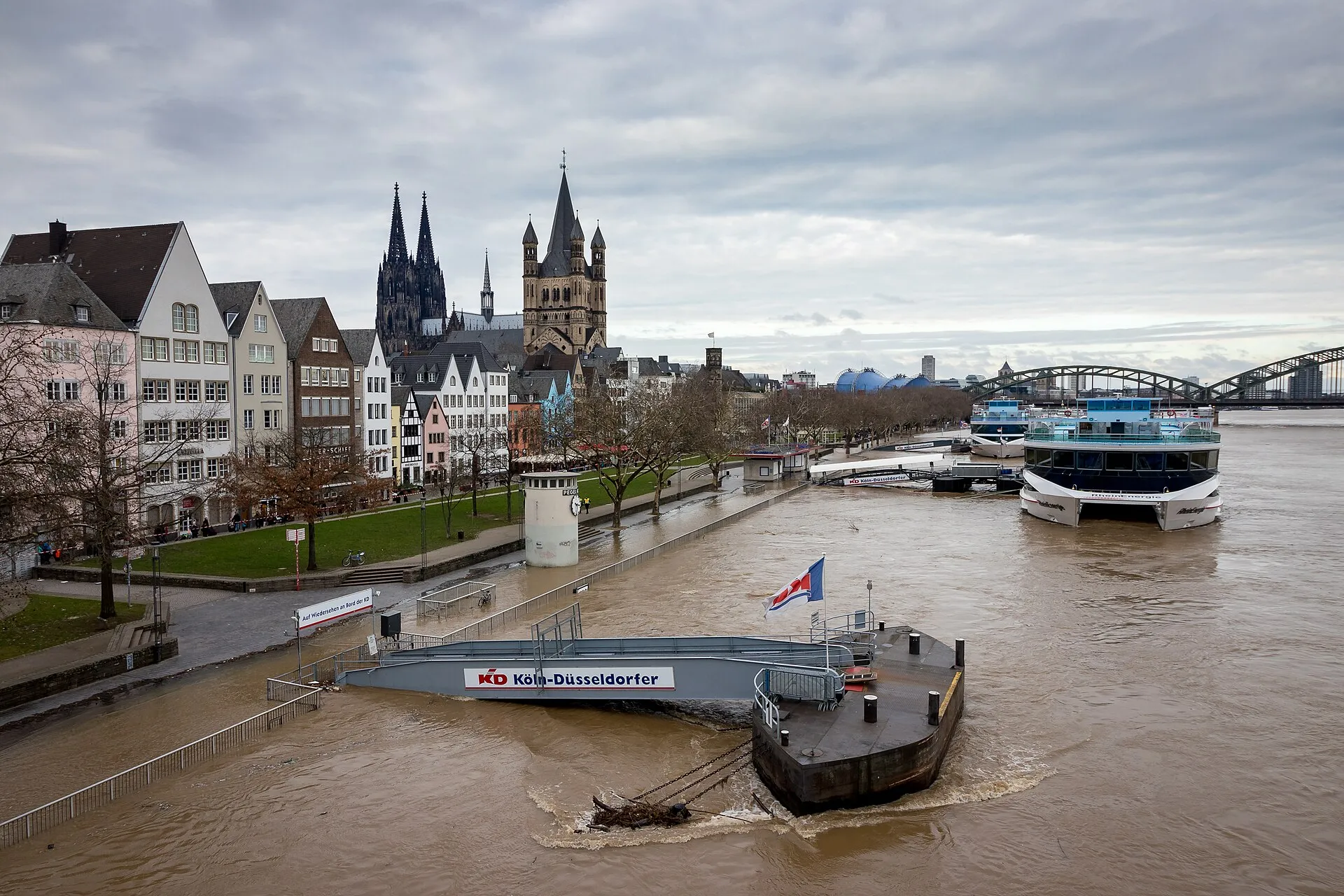 River Rhine in Cologne with floods in January 2018 . Stream gauge (named Pegel Köln ) on the left bank near Rheingarten stands a little bit in water. Ships can
