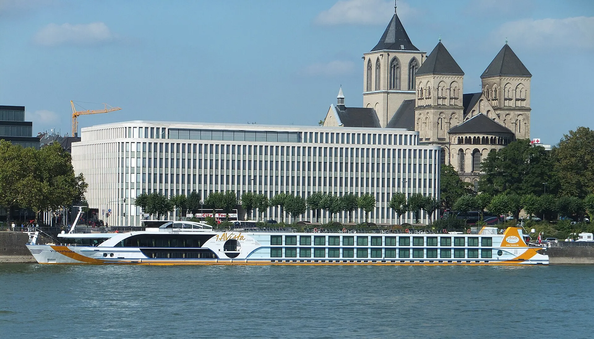 Ship "Vista Prima" on the Rhine in front of St. Kunibert and Institut der deutschen Wirtschaft in Cologne, Germany